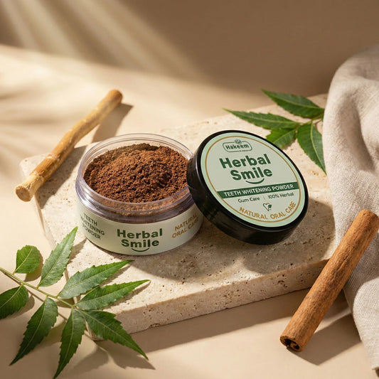 Herbal Smile teeth whitening powder with a jar of brown powder on a stone surface with cinnamon sticks and leaves.