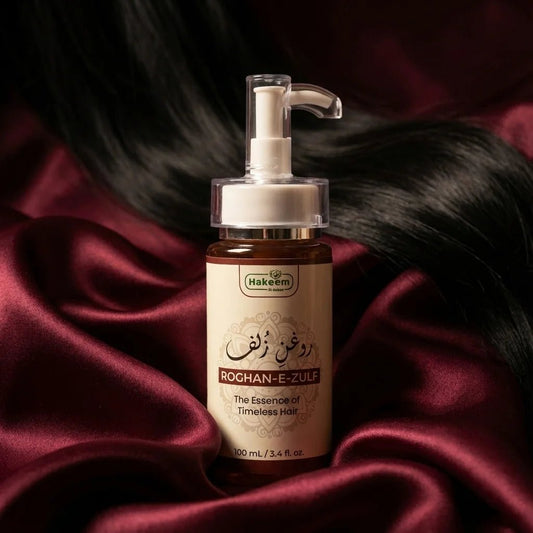 Bottle of Hakeem Roghan-E-Zulf hair product on a dark fabric background